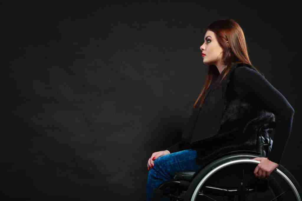 Sad Girl Sitting On Wheelchair. Disabled Depressed Woman. Health