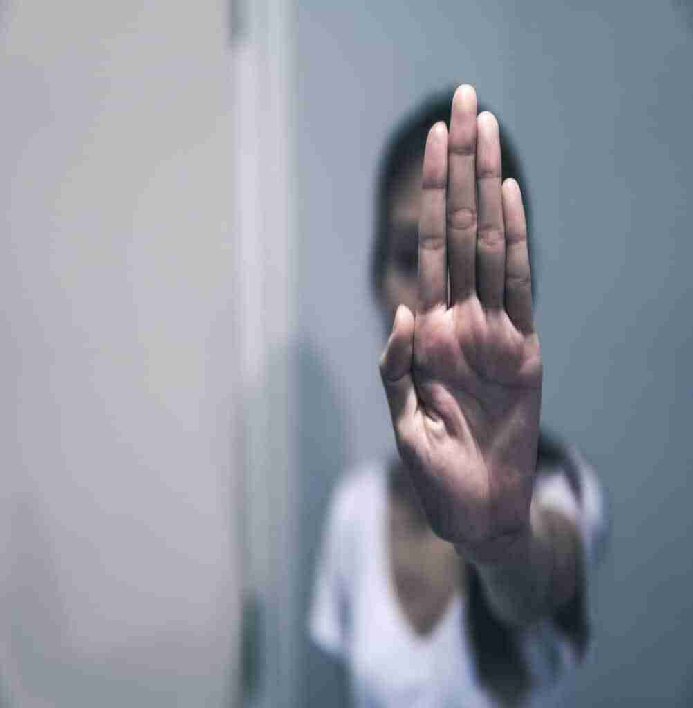 Women Abused In Her Home Holding Her Hand Up. Stop Sexual Harassment Against Women. Violence And Abu