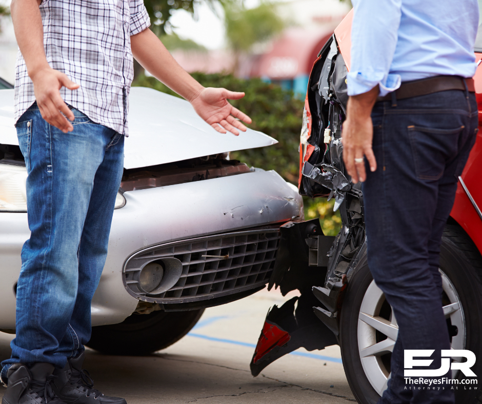 Two drivers discussing who is at fault in a car accident after a rear-end collision, with visible vehicle damage – Tampa car accident lawyer The Reyes Firm