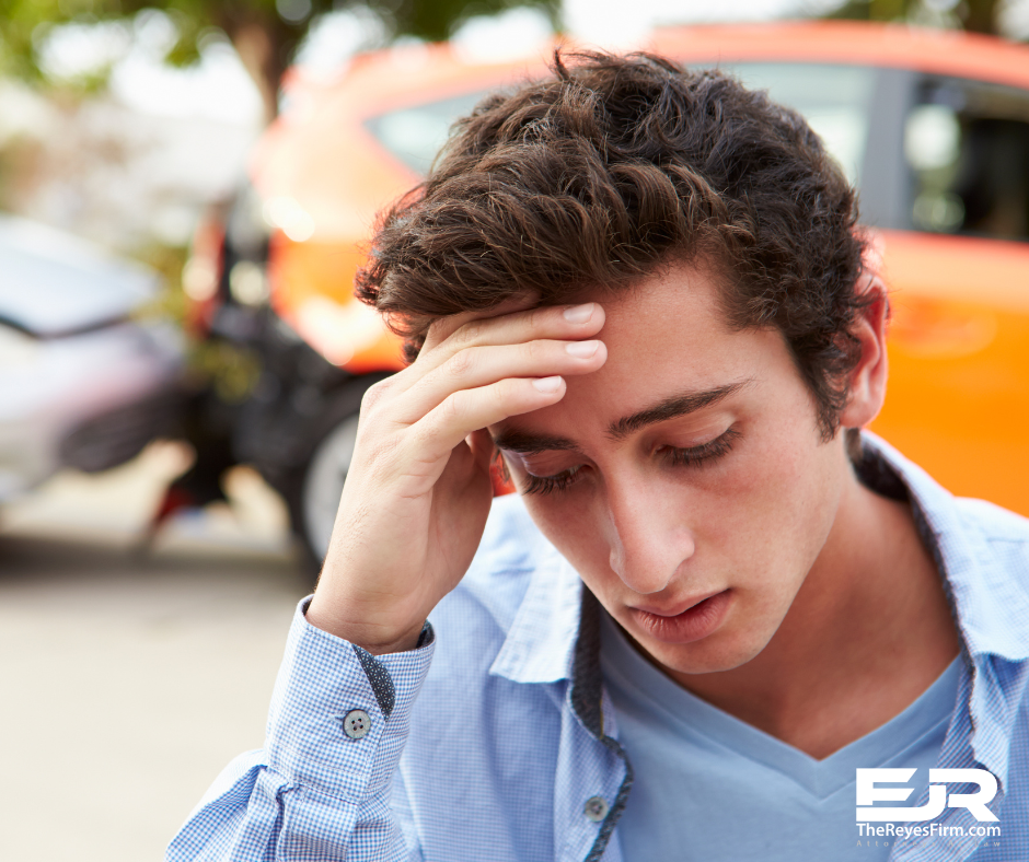 Young man with headache after a crash, showing signs of delayed injuries after a car accident – The Reyes Firm