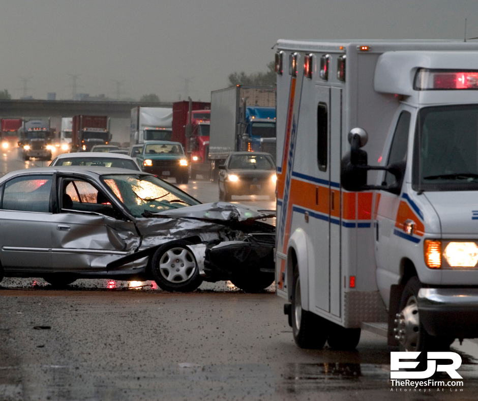 Tampa catastrophic car accident lawyer – ambulance at crash scene with damaged car on wet highway