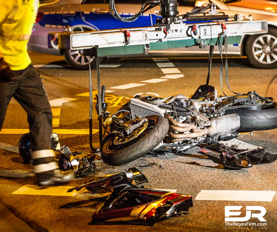 Tampa catastrophic motorcycle accident lawyer – damaged motorcycle being lifted by a tow truck after a serious crash at night with emergency responders nearby.