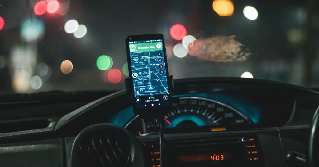 Navigation app mounted on dashboard of a rideshare vehicle in Tampa at night, for illustrative purposes only.